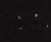 Many orbs with the orange Moon visible in the background